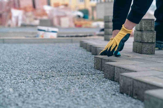 Driveway installation with pavers being placed on a gravel base for a residential property in Parma Heights, OH