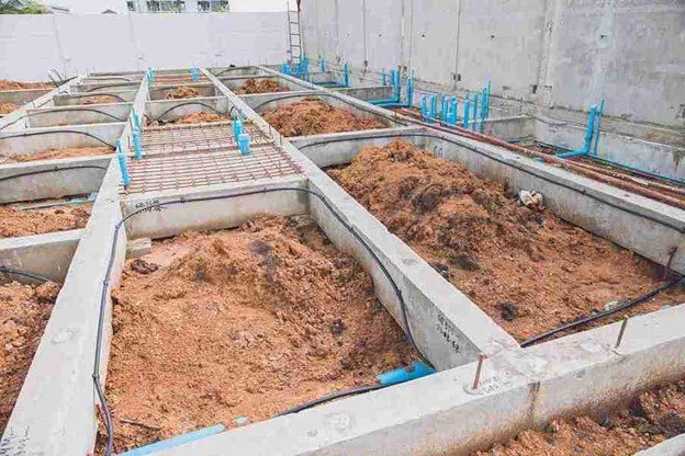Concrete foundation installation with footing layout and plumbing lines prepared for residential build in Parma Heights, OH