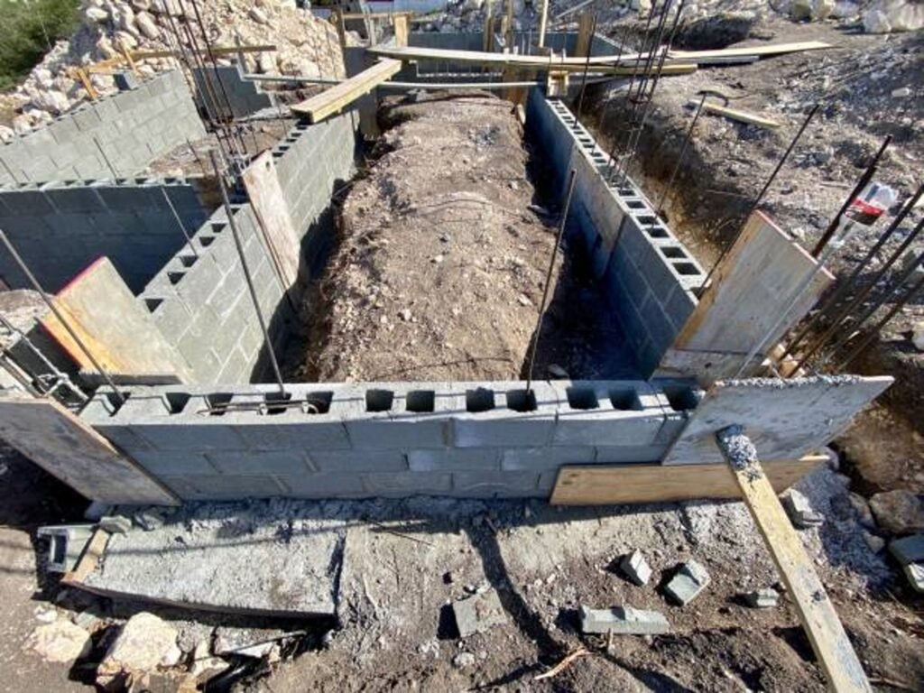 Concrete foundation installation with block walls and framing setup on the construction site in Columbia Station, OH