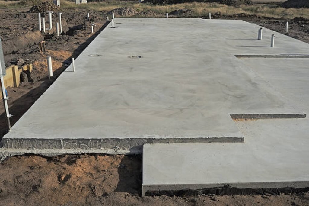 Newly poured concrete slab foundation with smooth finish and structural layout in Parma Heights, OH
