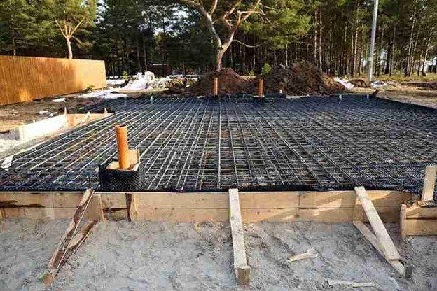 Concrete slab preparation with steel rebar reinforcement grid before pouring foundation in Parma Heights, OH
